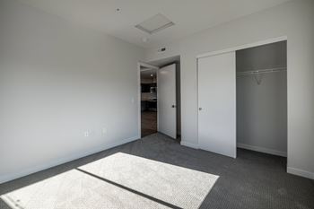 a view of a hallway with white pillars and a gray floor at Sagecrest Apartments, Washington